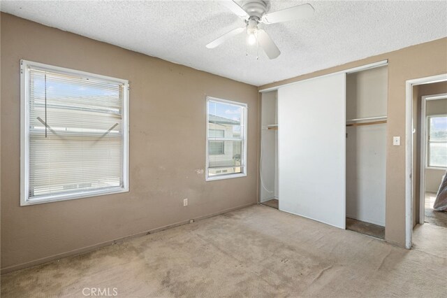 847 W 25th St, San Bernardino, CA 92405 - unfurnished bedroom with a ceiling fan, a closet, light carpet, and a textured ceiling