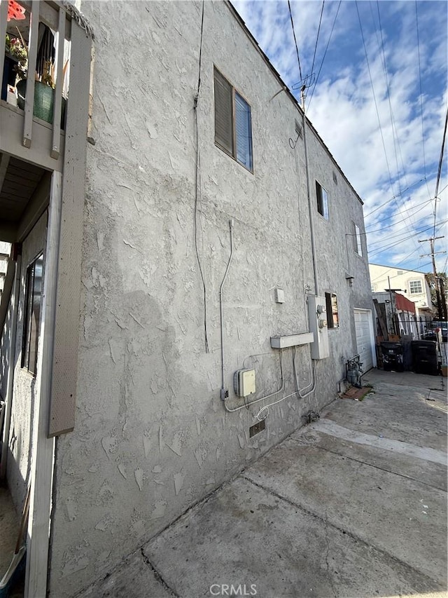 view of home's exterior with crawl space, a patio area, and stucco siding