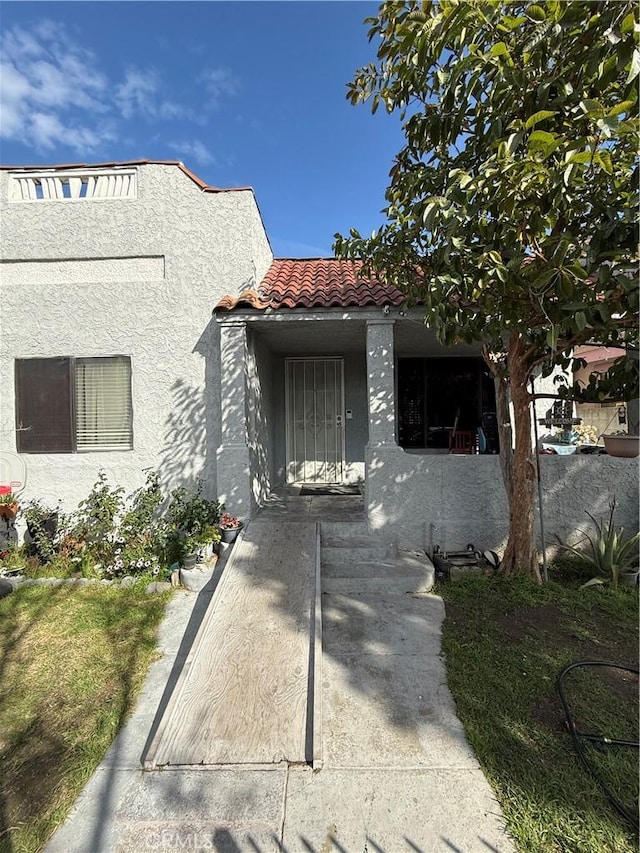 view of front of property with a tile roof and stucco siding