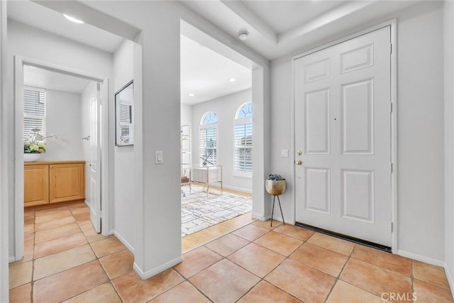 foyer with light tile patterned floors, baseboards, and recessed lighting