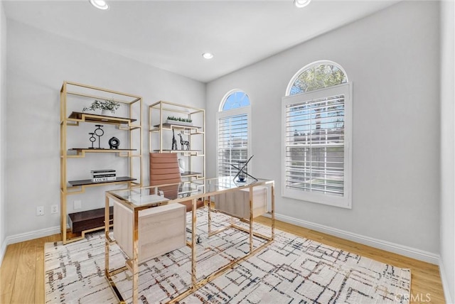 office space featuring light wood finished floors, recessed lighting, and baseboards