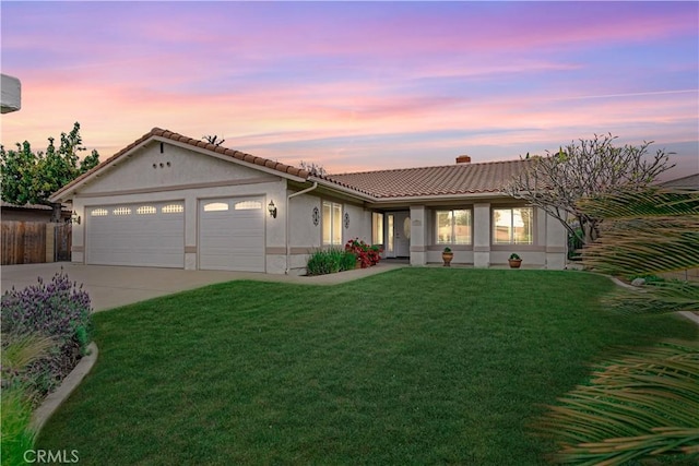 single story home with a tile roof, concrete driveway, stucco siding, an attached garage, and a yard