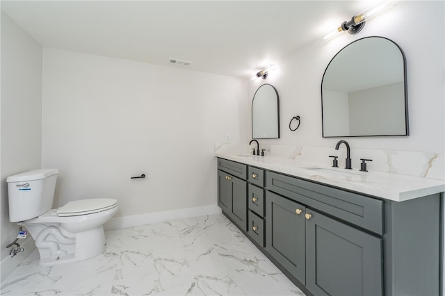 full bath featuring marble finish floor, a sink, toilet, and baseboards