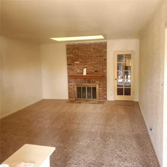 unfurnished living room with a fireplace, carpet flooring, and baseboards