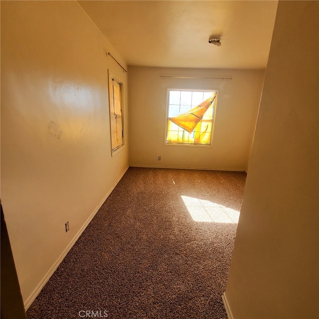 carpeted empty room with baseboards