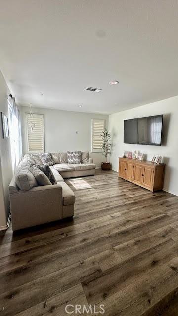 living room with dark wood finished floors and visible vents