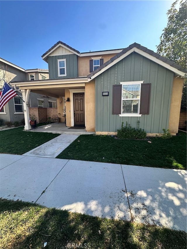 view of front of property featuring a front lawn and board and batten siding