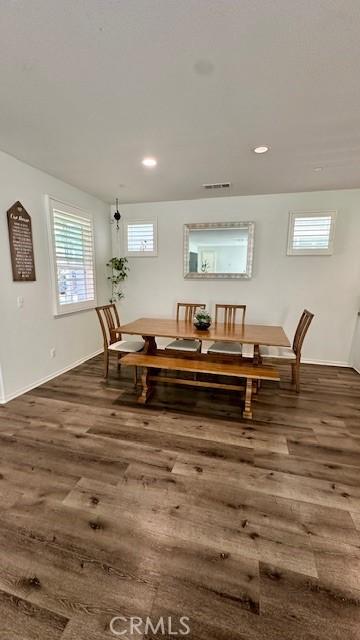 dining room with dark wood-style floors, baseboards, and recessed lighting