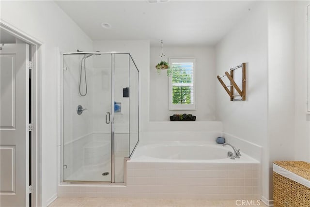 bathroom with a garden tub and a stall shower