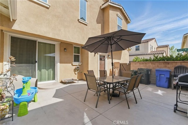 view of patio with fence and outdoor dining area