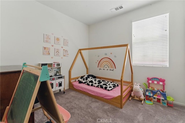 bedroom with carpet, visible vents, and baseboards
