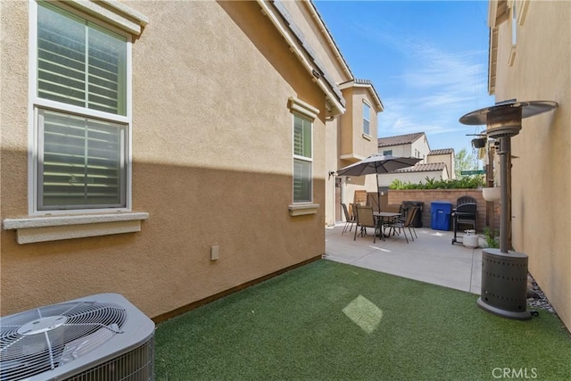 exterior space with cooling unit and fence