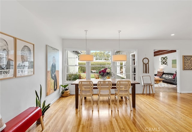 dining room featuring light wood-type flooring and baseboards