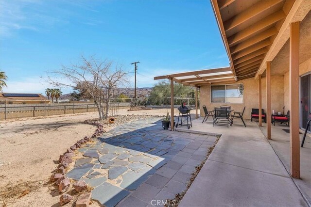 view of patio / terrace featuring outdoor dining space and fence