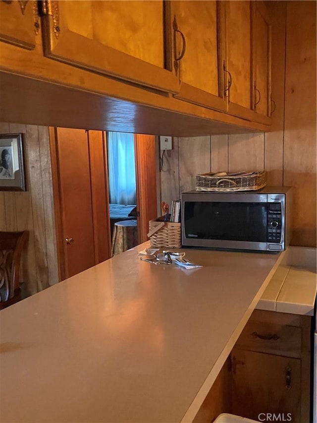 kitchen featuring brown cabinets and stainless steel microwave