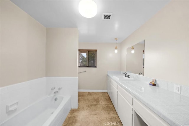 full bath with baseboards, visible vents, a bath, and vanity