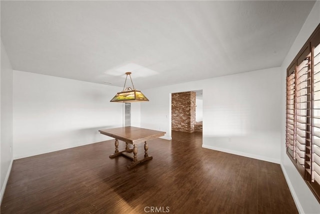 interior space with dark wood finished floors and baseboards