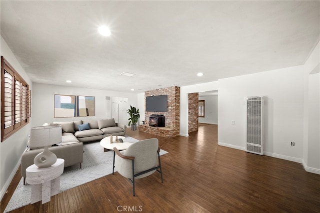 living area with recessed lighting, a fireplace, dark wood finished floors, and baseboards