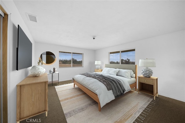 carpeted bedroom featuring visible vents and baseboards