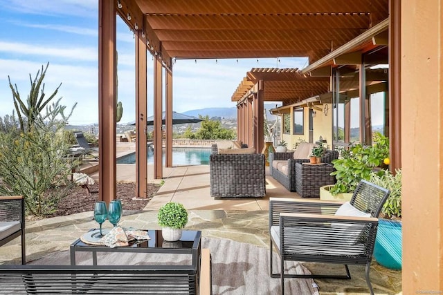 view of patio featuring an outdoor hangout area, a mountain view, a fenced in pool, and a pergola