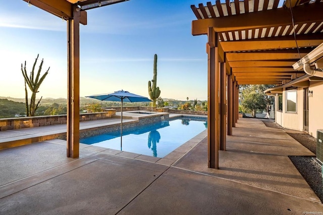 view of pool featuring a patio and a pool with connected hot tub