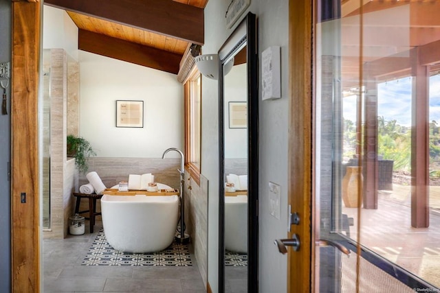 bathroom with vaulted ceiling with beams, a freestanding tub, and wood ceiling