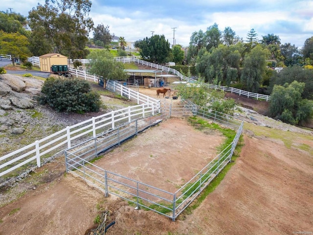 birds eye view of property with a rural view