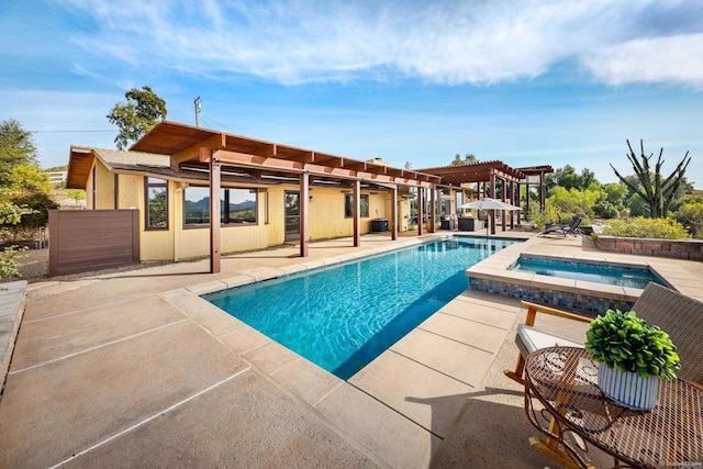 view of pool with a patio area, a pool with connected hot tub, and a pergola