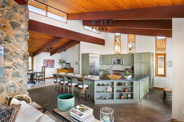 kitchen with stainless steel appliances, beamed ceiling, wooden ceiling, and green cabinetry