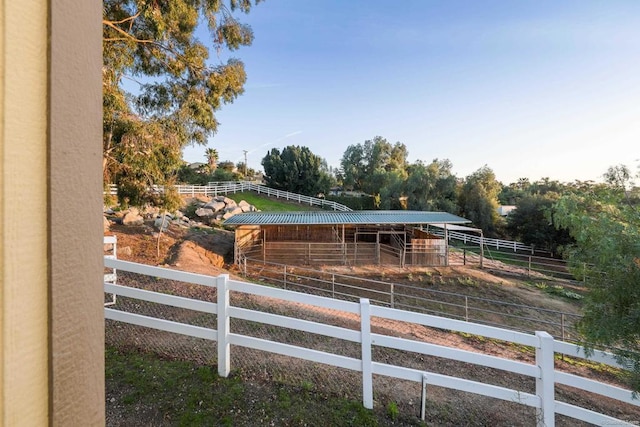 exterior space with a rural view, an outbuilding, and an exterior structure