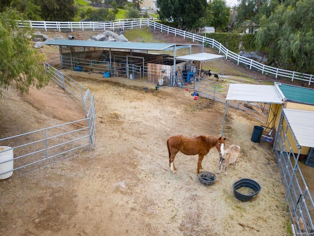 view of stable with a rural view