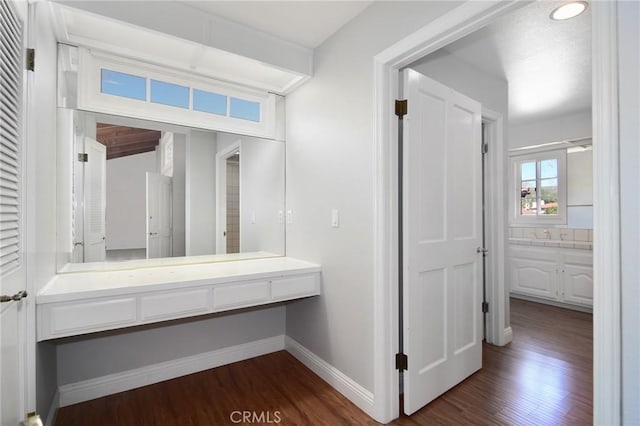bathroom with recessed lighting, wood finished floors, vanity, and baseboards