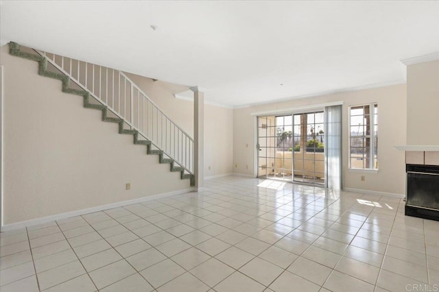 unfurnished living room with light tile patterned floors, stairs, a fireplace, and crown molding