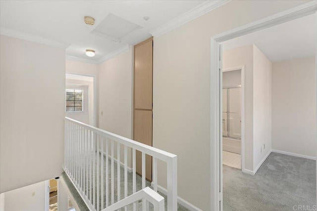 corridor with an upstairs landing, baseboards, crown molding, and light colored carpet