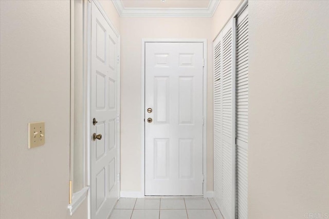 doorway featuring ornamental molding, baseboards, and light tile patterned floors