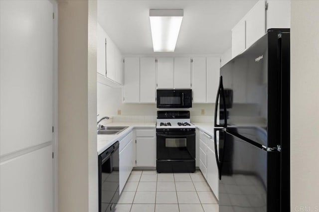 kitchen featuring light countertops, a sink, black appliances, and white cabinetry