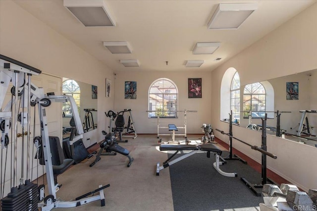 workout area featuring attic access and baseboards