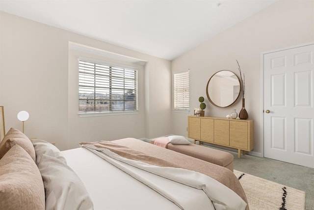 carpeted bedroom with lofted ceiling