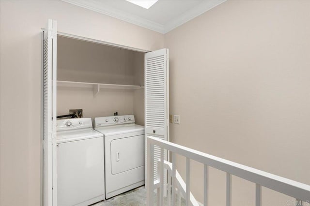 laundry area featuring ornamental molding, laundry area, and separate washer and dryer