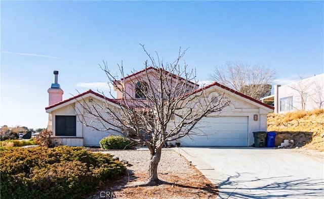 view of front of home with a garage, concrete driveway, a chimney, and stucco siding