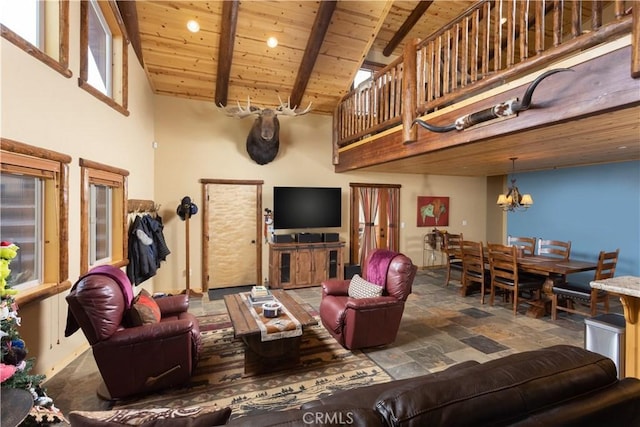 living area featuring a notable chandelier, stone finish flooring, high vaulted ceiling, wooden ceiling, and beamed ceiling