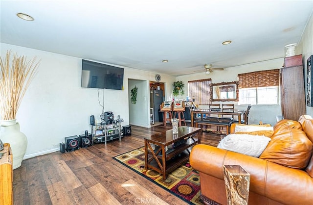 living room with dark wood-style floors and ceiling fan