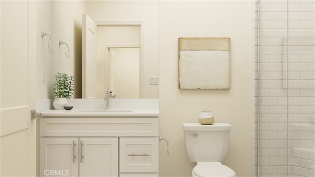 full bath with a tile shower, vanity, and toilet