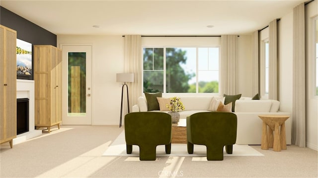 sitting room with a fireplace, baseboards, and light colored carpet