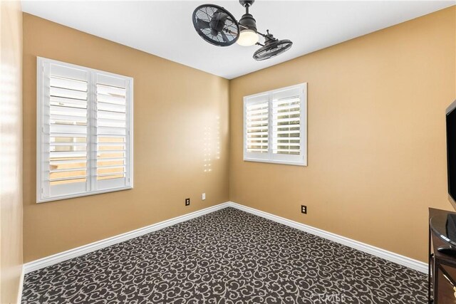 spare room with baseboards