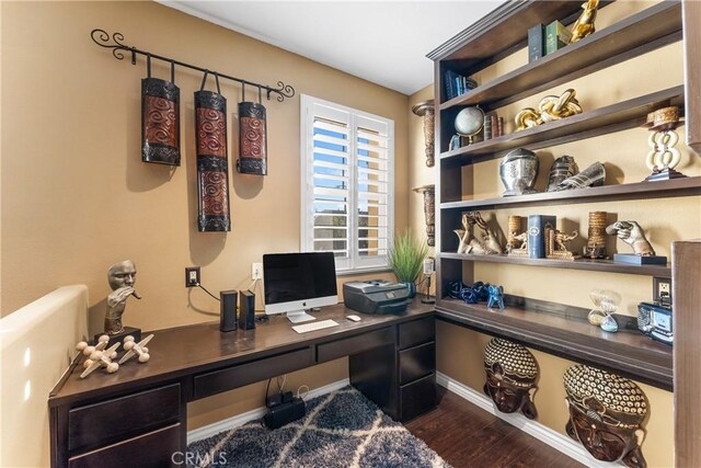 office area with dark wood-style flooring and baseboards