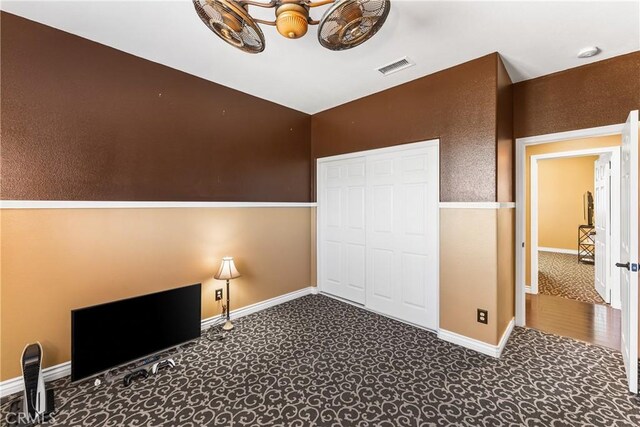 unfurnished bedroom with a closet, visible vents, and baseboards