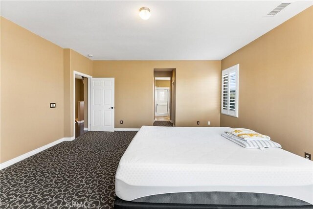 carpeted bedroom with visible vents and baseboards