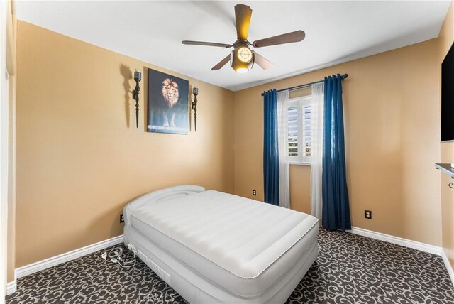 bedroom featuring a ceiling fan and baseboards