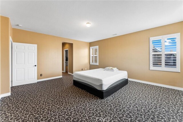 bedroom with carpet and baseboards